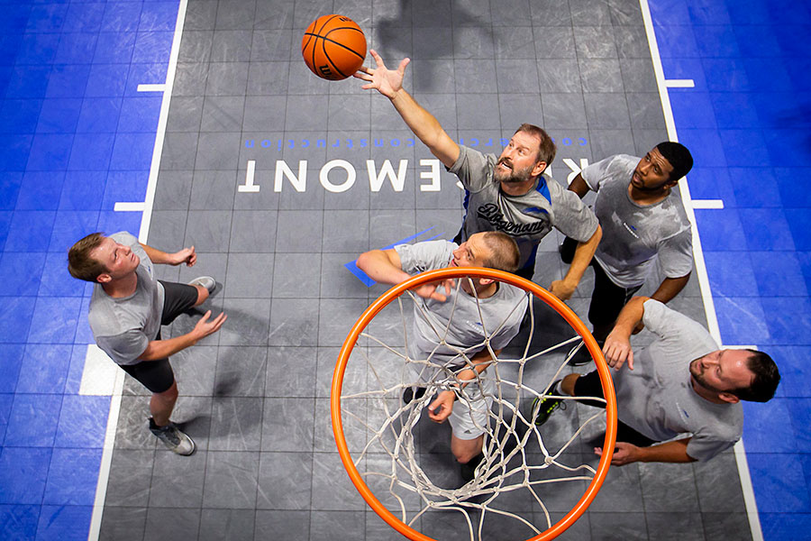 Paul Camp (top) reaches for a rebound during a basketball game with, Kevin Mezger (left), Micah Cunningham (bottom), David Levias (top right) and Joey Johnson (bottom right) at Ridgemont Commercial Construction on Wednesday, Aug. 8, 2018, in Irving. A regular Wednesday afternoon game takes place on the basketball court that has been added to their office warehouse featuring employees, friends and business partners.