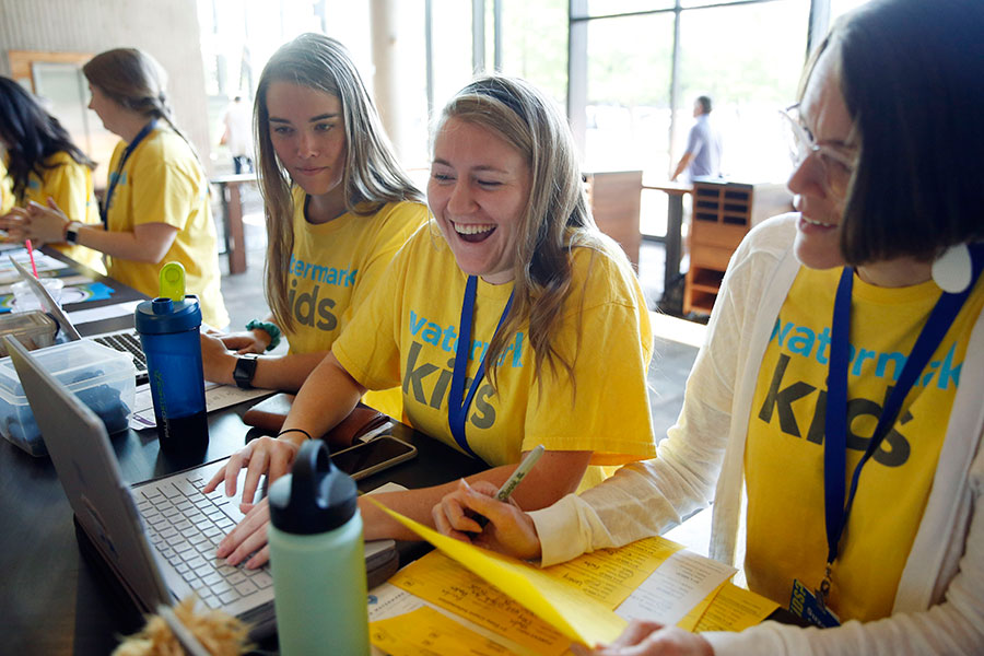 Mary Claire Carrick, Amy Gammenthaler, Suzanne Sanderson share in a laugh as they work in the Watermark kids area at Watermark Community Church in Dallas.