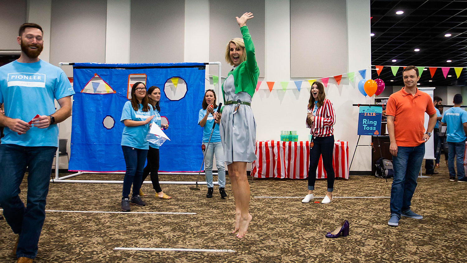 Julie Van Orden celebrates her success in a putting game during Pioneer Fair at Pioneer Natural Resources.